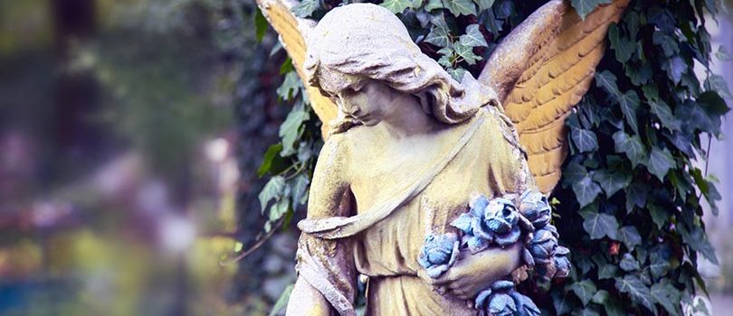 Vintage,Image,Of,A,Sad,Angel,Against,The,Background,Of Vintage image of a sad angel against the background of leaves (fragment)