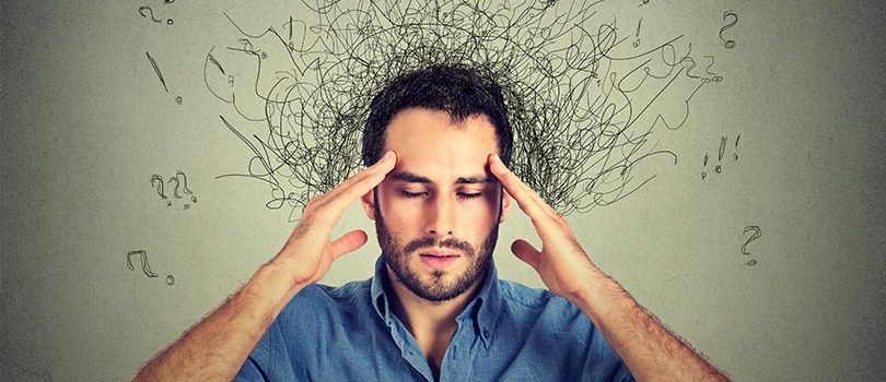 Closeup,Sad,Young,Man,With,Worried,Stressed,Face,Expression,And Closeup sad young man with worried stressed face expression and brain melting into lines question marks. Obsessive compulsive, adhd, anxiety disorders