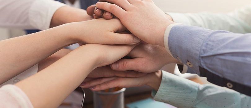 Teamwork and teambuilding, people connect hands Multiethnic team put hands together, connection, teambuilding and alliance concept. Crop of people in office unite for teamwork and cooperation, copy space