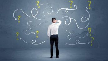 A,Salesman,In,Doubt,Can,Not,Find,The,Solution,To A salesman in doubt can not find the solution to the problem concept with curvy lined arrows and question marks drawn on urban wall