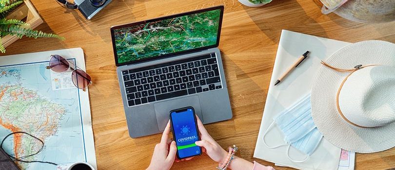 Top view of young woman with laptop planning vacation trip holiday, desktop travel covid-19 concept. A top view of young woman with laptop planning vacation trip holiday, desktop travel covid-19 concept.