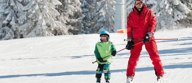 Ski instructor learning skiing Ski instructor learning little boy skiing