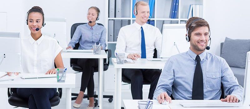 Telemarketers at work Smiled and satisfied telemarketers at work in office