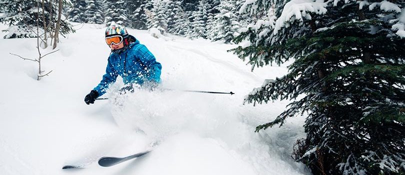 girl with special ski equipment is riding fast, jumping, freeriding very fast in the mountain forest