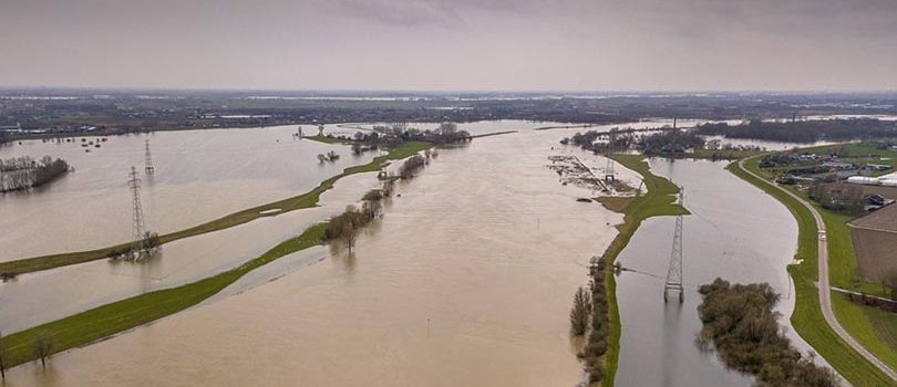 Flooded river landscape in winter Flooded river landscape with submerged floodplains along river Rhine in winter period near wageningen, the Netherlands