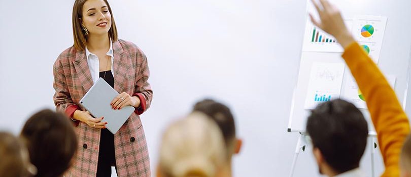 Young woman coach speaker giving flipchart presentation, speaker leading training Young woman coach speaker giving flipchart presentation, speaker leading training