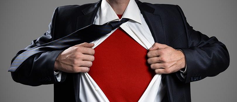 Businessman Acting Like A Super Hero And Tearing His Shirt, Isol Businessman Acting Like A Super Hero And Tearing His Shirt, Isolated On Gray Background. Copy Space.