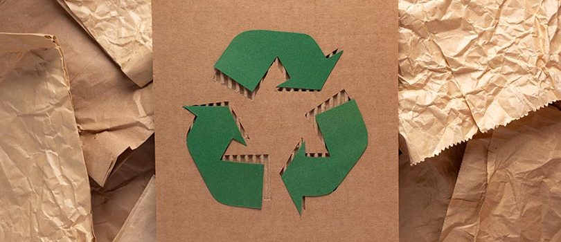 Recycle symbol on cardboard paper as background texture. Recycli Recycle symbol at cardboard paper as background texture. Recycling idea concept and brown paper