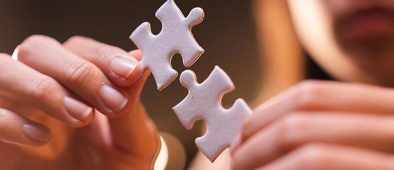 Concept of integration and startup with puzzle pieces merger with teamwork of business worker partners hand close-up, positive connection partnership in modern office for business marketing job work
