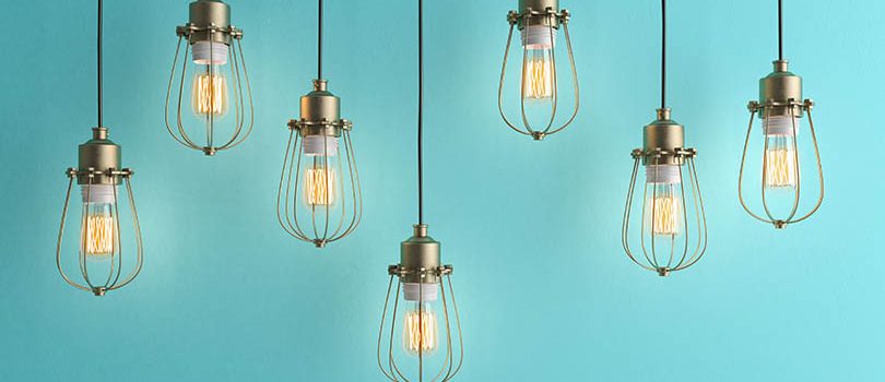 Seven vintage lamps hanging from the ceiling with blue wall 3D renderind Master