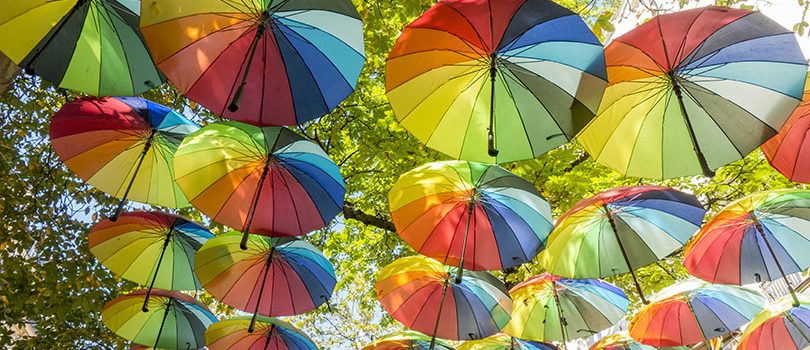 Hanging rainbow umbrellas in the sky during the gay pride in the Marais district of Paris, France The hanging rainbow umbrellas in the sky during the gay pride in the Marais district of Paris, France