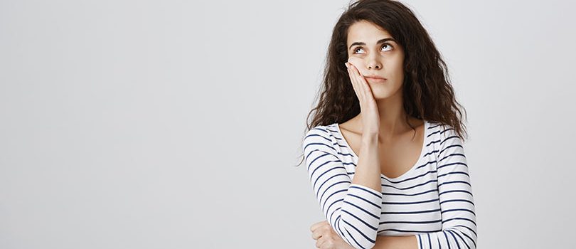 Girl screaming internally from boredom. Cute emotive curly-haired caucasian female making facepalm and rolling eyes from annoyance, hearing nonsense or boring conversation, standing over gray wall Girl screaming internally from boredom. Cute emotive curly-haired caucasian female making facepalm and rolling eyes from annoyance, hearing nonsense or boring conversation, standing over gray wall. Emotions concept