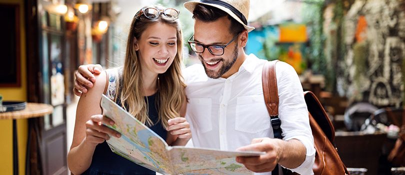 Tourist couple traveling. Travel. Walking on street. Portrait of beautiful young people Travel. Tourist couple traveling, Walking on street. Portrait of beautiful young people